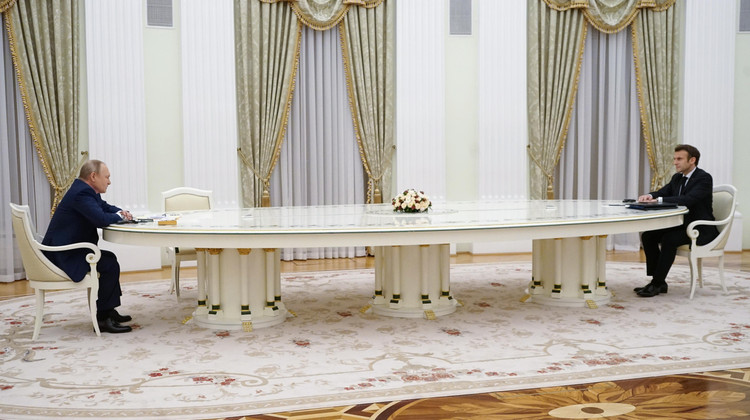 putin_and_macron_meeting_with_a_large_table.jpg